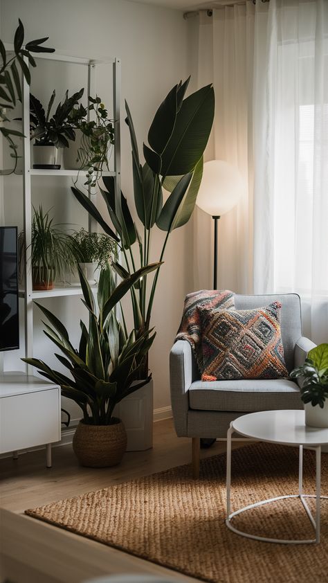 Transform your living room into a tropical oasis with this stunning IKEA-inspired setup! Featuring elegantly arranged tropical plants on a sleek white shelving unit, cozy armchair, and vibrant patterned throw pillow, this space exudes relaxation and style. The minimalist coffee table and woven rug add character, while soft lighting from a floor lamp creates an inviting atmosphere. Ready to bring a touch of the tropics into your home? Discover how to achieve this look and make your living area a serene escape! #TropicalDecor #IKEAStyle #HomeInspiration Ikea Minimalist Living Room, Ikea Minimalist, White Shelving, White Shelving Unit, Cozy Armchair, Ikea Style, Minimalist Coffee, Minimalist Coffee Table, Tropical Oasis