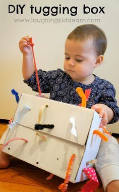 DIY tugging box for young toddlers. When they pull at one end it lengthens and shortens the ribbon at the other. Great for learning cause and effect and problem solving.  Laughing Kids Learn Activities For Babies Under One, Activities For Babies, Baby Sensory Play, Baby Toys Diy, Baby Play Activities, Baby Learning Activities, Toddler Play, Toddler Fun, Baby Sensory