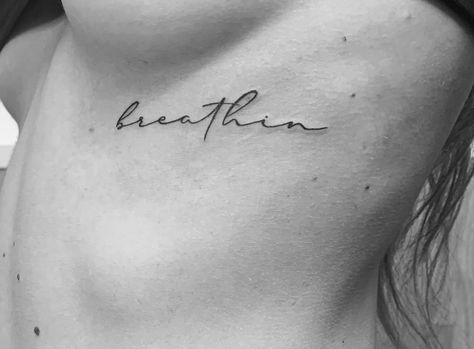 Ariana Grande Rib Tattoo, Breathin Tattoo Ariana Grande, Just Keep Breathing Tattoo, Keep Breathing Tattoo, Breathin Tattoo, Ariana Grande Tattoo Ideas, Ariana Tattoos, Inscription Tattoo, Divorce Healing