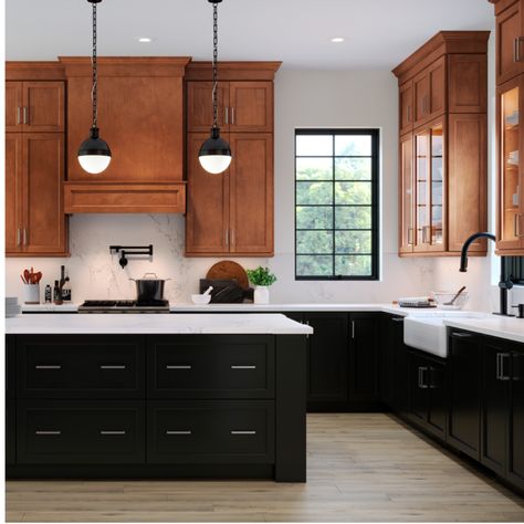 Black can be warm and welcoming, especially used as an accent color with a wood-tone finish. Try rich maple cognac upper cabinets paired with painted black lower cabinets and a painted black island. #waypointlivingspaces #kitchencabinets #cabinets #remodel #kitchendecor #kitchenstyle #kitchenideas #blackcabinets Kitchen Black Lower Cabinets, Wood Upper Painted Lower Cabinets, Brown Upper Cabinets White Lower, Black Cabinets Oak Floor, Kitchen Wood And Black Cabinets, Kitchen Black And Wood Cabinets, Black Cabinets Wood Shelves, Maple Kitchen Cabinets With Black Island, Black And Light Wood Kitchen Cabinets