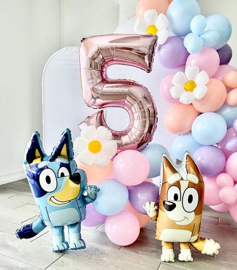 Welcome to Sweet Escapes By Debbie  Make your Bluey-themed party extra special with our Bluey and Bingo Balloon Garland! This colorful and fun balloon garland is the perfect addition to any celebration, bringing the beloved characters Bluey and Bingo to life.  Balloon towers are the perfect way to add that wow to your party. With helium prices increasing and sometimes hard to find this is the perfect balloon option filled with air! This kit includes everything you need to create your tower. This is a great accent or stunning centerpiece for your party. It is also great as a photo prop! Included in each DIY kit: Colors pink, matte blue, melon and blossom ~ 12 11" latex balloons ~ 3 balloon clips ~ One pink number ~ One 12" mylar daisy ~ Glue dots ~ Add on Bluey, Bingo or both! ~ (1) Dual ac Diy Bluey Centerpieces, Bluey Birthday Party Girly, Bluey Party Centerpieces, Bingo Birthday Party Theme, Bluey Birthday Party Ideas Pink, Diy Bluey Birthday Decorations, Bluey Diy Party, Bluey Balloon Garland, Bluey And Bingo Cake