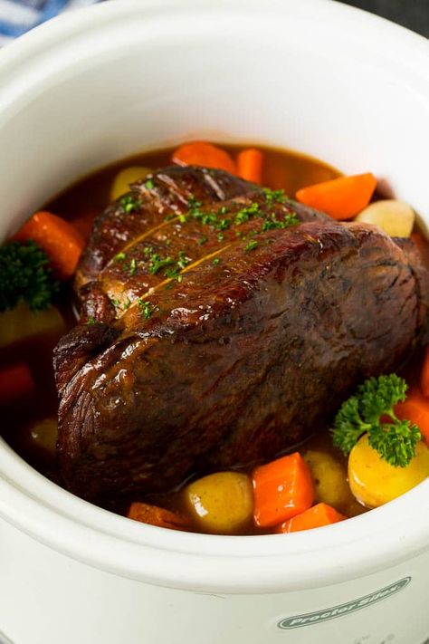 Slow cooker pot roast simmered to tender perfection with potatoes and carrots in a savory gravy. #beef #slowcooker #dinner #dinneratthezoo Beef Topside Roast Slow Cooker, Inside Round Roast Slow Cooker, Slow Cooker Round Roast, Carrots Slow Cooker, Beef Roast Crock Pot, Roasted Potatoes And Carrots, Boiled Dinner, Slow Cooker Roast Beef, Slow Cooker Recipes Beef