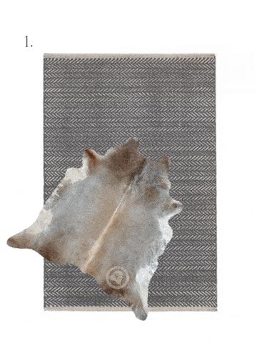 Layering Rugs With Cowhide Dining Room, Antelope Area Rug Living Room, Animal Skin Interior Design, Rug Under Desk In Bedroom, Cowhide Rug In Living Room, Cow Hide Rug Layered, Faux Cowhide Rug Living Rooms, Layered Cowhide Rug Living Room, Layering Cowhide Rug Living Room