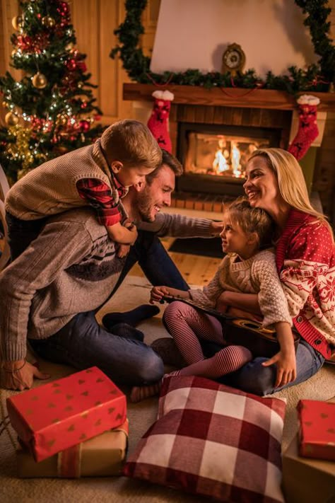 Young happy family communicating on Christmas Eve in the living room. Christmas Photography Family, Christmas Poses, Christmas Family Photoshoot, Christmas Tree Lots, Christmas Card Pictures, Family Christmas Pictures, Christmas Shoot, Merry Christmas Images, Christmas Family Photos