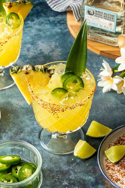 Made with fresh pineapple juice and poblano liqueur, this spicy pineapple margarita is an exciting, tropical twist on the classic tequila cocktail. This refreshing margarita is served on the rocks and garnished with fresh jalapeño and a salted chili rim. Tropical Margarita Recipe, Virgin Mocktail, Traditional Margarita Recipe, Spicy Pineapple Margarita, Classic Tequila Cocktails, Pineapple Margarita Recipe, Margarita Mocktail, Negroni Recipe, Spicy Pineapple