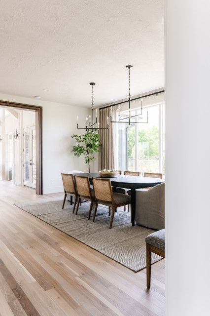 English Tudor Homes Interior, Masculine Dining Room, Double Chandelier, Dining Room Lighting Over Table, Dark Brown Dining Table, Dark Wood Dining Room, Tudor Interior, Lighting Over Table, Plank Hardwood Floors