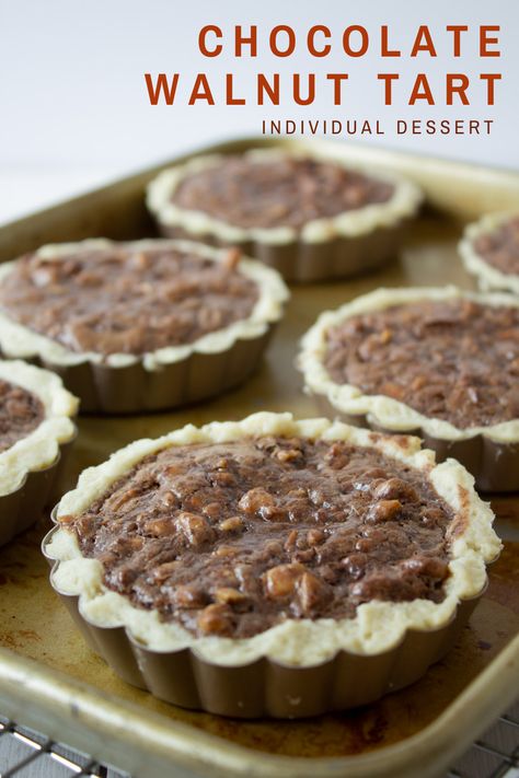 Mini chocolate walnut tarts make an individual sweet treat. This decadent dessert has a rich chocolate filling topped with walnuts on a flaky crust. Walnut Tart, Mini Tart Recipes, Brownies Recipe Homemade, Individual Desserts, Crumble Recipe, Flourless Chocolate Cakes, Toasted Walnuts, Chocolate Filling, Chocolate Tart