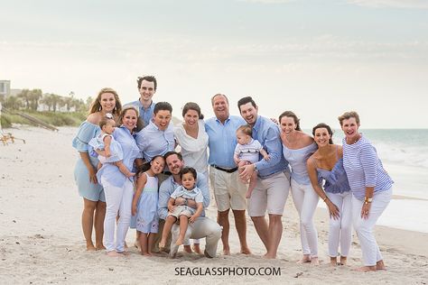 Family poses on the beach at Johns island beach club all matching during family photos in Vero Beach Florida Beach Family Pictures Outfits, Family Beach Photos Outfits, Beach Family Photos Outfits, Poses On The Beach, Seaglass Photography, Family Photos On The Beach, Family Beach Pictures Outfits, Beach Picture Outfits, Family Photo Colors