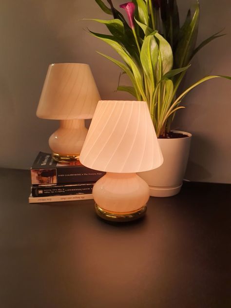 A pair of 1970s Mid-Century Modern Murano glass mushroom table lamps in a peach-pink swirl design. Handcrafted in Italy with Scandinavian design influence, these vintage MCM bedside lamps add a soft glow, showcasing timeless craftsmanship and style. Murano Mushroom Lamp, Mid Century Modern Scandinavian, Mushroom Table, Glass Mushrooms, Mushroom Lamp, Pink Swirls, Modern Scandinavian, Swirl Pattern, Bedside Lamp