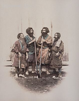 The two men in the middle are holding rifles. The second man from the right is wearing an apron with a knife (?). The man on the right is wearing earrings and carrying a knife sheath at his waist. The man on the left is probably holding a hatchet. (This is the same as photograph #3966). Ainu People, Golden Kamui, An Apron, Ethnic Art, Knife Sheath, Nagasaki, Two Men, Fantasy Inspiration, Japanese Culture