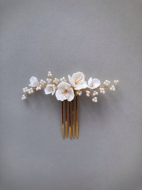 Delicate and stunning floral comb is crafted with handmade Porcelain flowers and small matte beads. Use this flower hair comb to accentuate an updo or add a whimsical touch to loose waves. So small the comb is well attached and holds even on short hair (if necessary, it can be fixed with a bobby pin). This bridal hair piece is versatile and can complement any wedding gown design. Available on silver and gold wire. Length: 9 cm ( 3.5 inch) If you like this bridal hair comb, I recommend that you s Floral Hair Pins Hairstyles, Tropical Wedding Hair Piece, White Flower Hair Accessories, Bridal Floral Hair Piece, Wedding Hair Decoration, Hair Accessories Bride, Bridal Hair With Comb, Gold Hair Piece Wedding, Flower Head Piece