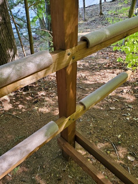 Homemade Kayak Rack made out of wood.  Boat storage for kayaks, canoes and paddle boards.  Foam noodles to protect against damage. Kayak Stand Diy Storage Racks, Canoe And Kayak Storage Rack, Wood Kayak Rack, Outdoor Kayak Rack, Kayak Rack Diy Wood Plans, Diy Canoe Rack, Kayak Storage Racks Outdoor Diy, Outdoor Kayak Storage Diy, Kayak Racks For Storage