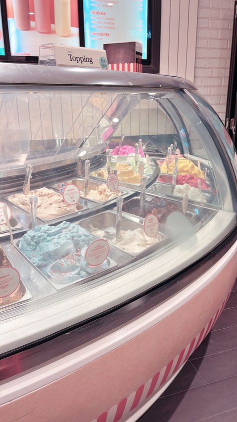 Pastel ice cream parlour with many flavours of ice cream in a glass case Ice Cream Maker Aesthetic, Japan Ice Cream Shop, Ice Cream Parlour Aesthetic, Old Fashion Ice Cream Shop, Pink Ice Cream Aesthetic, Japanese Ice Cream Shop, Ice Cream Store Aesthetic, Beach Ice Cream Shop, Ice Cream Parlor Aesthetic