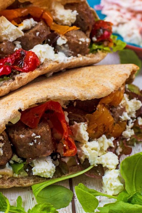 Fluffy pita bread pockets stuffed with hummus, tzatziki, salad and roasted vegetables and then topped with freshly grilled mint lamb kofta and a sprinkling of feta. This Stuffed Lamb Pita recipe is seriously loaded and will take your lunch times to the next level. Great for serving up to a crowd and can be easily cooked on a BBQ too. Lamb Pita, Tzatziki Salad, Bread Pockets, Pita Recipe, Stuffed Lamb, Lamb Kofta, Pita Recipes, Grilled Halloumi, Lamb Meatballs