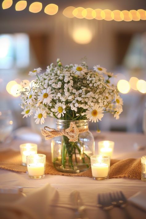 Add natural charm to your wedding with rustic centerpieces featuring wood, burlap, and mason jars. See more inspiration here. Blue Mason Jars Centerpiece, Bougie Country Wedding, Mason Jar Fairy Lights Wedding, Country Chic Centerpieces, Twine Mason Jars, Farm Table Decor Ideas, Diy Thrifted Wedding Decor, Mason Jar Centerpieces Table Decorations, Thrift Wedding Decor