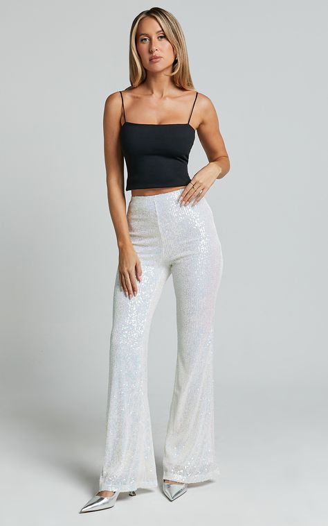 Get ready to party it up in our Deliza Pants! This fun and dreamy sequin pant is the statement piece you didn't know you needed. It features a flattering high rise waist, flared legs and glimmering sequins all over. They're perfect for parties and those nights out where you want to make a head-turning statement. Team them with a crop top, heeled sandals, fine jewellery and a mini handbag, and you'll be ready to dance the night away! Please note: the white sequin embellishments reflect as blue an White Sparkly Pants, White Fitted Festive Pants, White Sequin Flare Pants, Fitted Glitter Disco Pants, Sparkly Jeans, Disco Sequin Full-length Bottoms, Disco Style Sequined Full-length Pants, Sparkly Pants, Sequin Flare Pants