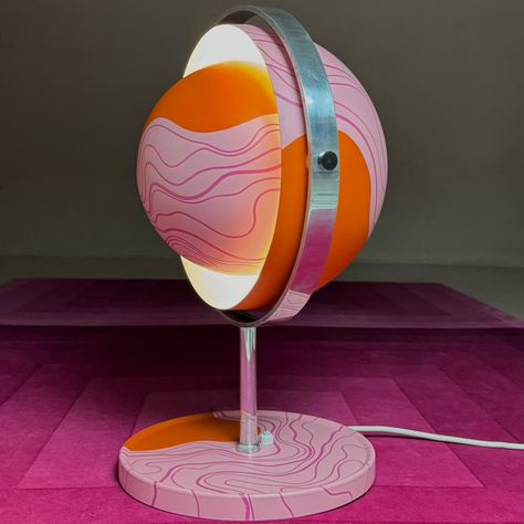 "Stunning unique and large space age Moonlight table lamp by Buch & Jørgensen, Denmark 1963. A playfull lollipop lacquered satin surface of orange and two toned pink color is what makes this stunning light stand out. Splashed pattern to the two spherical shaped shades and the large base makes the light an eye catcher from every angle. The two shades can be directed 360 degrees inside the chrome rim - this makes the light a versatile piece which allow you to play with the light effects. Whether you choose to have a direct or indirect light the lamp stands out.  Excellent condition without any dents at all. Very few traces of wear. Light source: E27 edison screw fitting max 75W. Comes with new wiring and new switch built in to the base.  Size: 42cm / 16.5\" high and 30cm / 11.7\" wide." Space Age Home Decor, Space Age Christmas, Retro Futurism Interior Design, Weird Lamps, Space Age Decor, 80s Room Decor, Water Genasi, Space Age Furniture, Lisbon Apartment