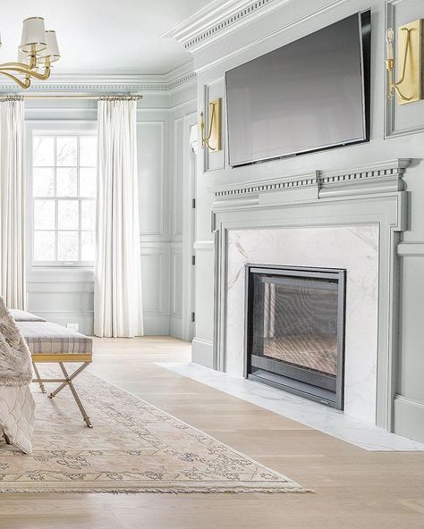 This room is bathed in the same blue gray color (Varying strengths of Benjamin Moore Boothbay Gray) brass accents and calacutta marble. The detailed mantel and dentil additions are classic Raised Panel Wainscoting, Panel Wainscoting, Fox Group, Blue Gray Color, Guest Bedroom Decor, House Bedrooms, Fireplace Makeover, Creative Things, Bedroom Goals