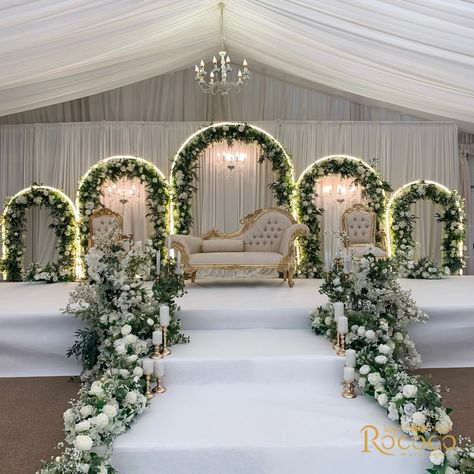 Absolutely loved creating this stunning wedding decor! 🤍 Swipe to see one of our favorite setups yet. #WeddingDecor #EventStyling Decor: @rococo.events Venue: @keythorpemanor #weddingdecorators #weddingdecorinspiration #eventdecorators #floraldecoration #weddinginsporation #ukweddingplanners #floralwedding white, green, gold, wedding theme, staging, archway, floral arch, table decor Walima Decoration Wedding Ideas, Green And White Wedding Stage Decor, White Floral Stage Decor, Wedding Decor Set Up, White And Green Themed Wedding, Unique Reception Decor, Wedding Hall Stage Decoration, White And Green Wedding Decor Reception Ideas, Nikkah Wedding Decor