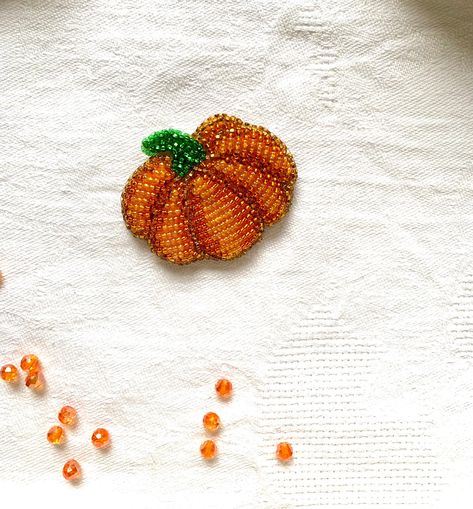 Decoration pumpkin gift for Halloween. Beaded pumpkin will decorate your Hollow and Thanksgiving day. You can make a gift to your friend or mom. Orange decoration is a symbol of autumn For this brooch, you can purchase an orange-green choker. It will be very relevant for the fall. Care and cleaning instructions: - store in a dry place, preferably in a box; - do not use water or chemicals for cleaning; - wipe gently only with a dry cloth or brush if you need to add shine - try not to get hairspra Halloween Beaded Embroidery, Halloween Bead Embroidery, Beaded Embroidery Christmas, Bead Embroidery Patterns Beadwork Design, Embroidery Gifts For Friends, Beading Clothes, Beaded Pumpkin, Beaded Orange, Green Choker