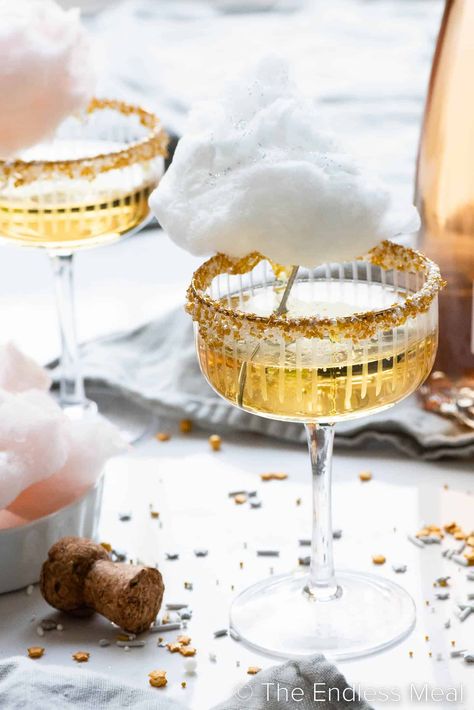 This cotton candy champagne is bubbly, sweet, and perfect for parties! It's sparkling wine served in a sprinkle-rimmed glass, then topped with a cloud of cotton candy. It'll take your party to the next level, and it's ready in minutes! #theendlessmeal #cocktail #drinks #cottoncandy #champagne #celebration Nye Champagne, Champagne Party Ideas, Maple Cotton Candy, Champagne Recipes, Cotton Candy Drinks, Cotton Candy Cocktail, On Cloud Wine, Champagne Recipe, Cotton Candy Champagne