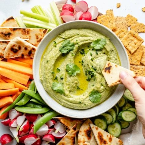 Fresh and flavorful pesto hummus made with homemade cilantro pistachio pesto for the most delicious dip, spread, and even sauce! This easy pesto hummus recipe comes together in under 30 minutes and will be your new favorite appetizer or snack. #hummus #vegan #healthysnack #healthyappetizer #pesto Best Pesto, Hummus Flavors, Pesto Hummus, Edamame Hummus, Pistachio Pesto, Ambitious Kitchen, Healthy Appetizer Recipes, Veggie Dip, Homemade Hummus