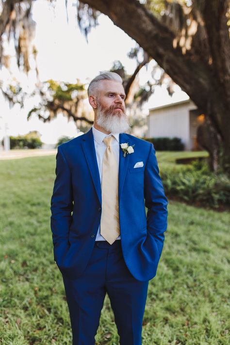 This bright royal blue suit and sun-kissed yellow tie are the perfect style combo for a classic Florida wedding. Navy Suit With Yellow Tie, Blue And Yellow Groomsmen Attire, Blue Suit Yellow Tie, Yellow Wedding Suit, Royal Blue Groomsmen, Royal Blue Wedding Suit, Blue And Yellow Suit, Men Blue Suit, Royal Blue Suit Wedding