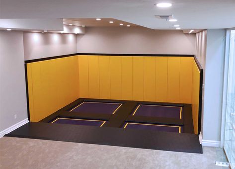 Bring the heart pumping entertainment of a trampoline park to your indoor play space. Inspired by trampolines found at family entertainment centers, our team helped this homeowner incorporate a trampoline court into his newly built recreation room. Custom designed for his space, we incorporated premium grade wall pads, purple trampoline beds with yellow stripes and a durable frame pad that protects kids from the trampoline springs and frame. Indoor Play Space, Trampoline Ideas, Sunken Trampoline, Indoor Playground Design, Trampoline Springs, Trampoline Room, Indoor Playroom, Recreation Room, Backyard Trampoline