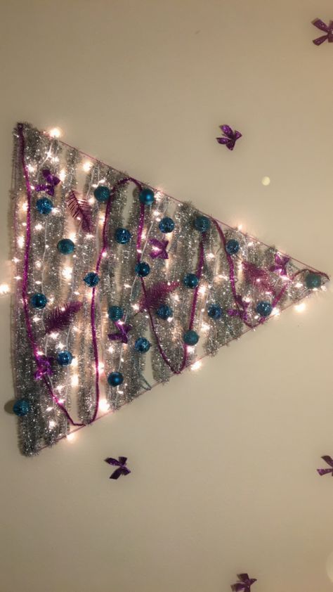 DIY garland Wall Christmas tree Garland Christmas Tree On Wall, Tinsel Tree On Wall, Christmas Tree On Wall, Diy Wall Christmas Tree, Tinsel Ideas, Christmas Tree Wall Hanging Michaels Stores, Fairy Lights Christmas Tree On Wall, String Light Christmas Tree On Wall, Tree On Wall