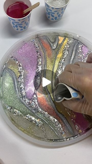 SharableArt by Shara Johnson on Instagram: "Just Resinating! 😍

This is the bottom of the tray from yesterday’s reel. I really think you could flip this tray over for a new look! The bottom was just as fun to create as the top. More to come soon! 🥰

@lrisystore for my gorgeous chunky  glitter 
15% off with code Sharableart 

@letsresin for my crystal clean resin 

@temu for molds and dust glitter

#makeitsparkle #addglitter #marble #resinartist #shinebright #artist #epoxy #glitterart #siliconemolds #tutorial #glitter #moresparkle #elegance  #paintwithresin #resincreations #abstract #painting #giftofgiving #inspiration #resintray #glitterpaint #resincoaster #fluidartwork #watchmework #epoxyresin #dreambig #sharajohnson #sharableart" Marble Effect Resin, Resin Works, Resin Art Canvas, Abstract Resin Art, Resin Trays, How To Clean Crystals, Resin Crafts Tutorial, Resin Jewelry Diy, Resin Tray