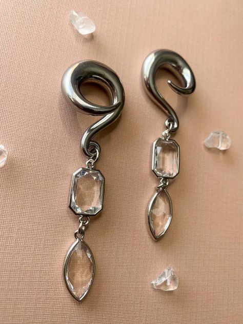 Silver Glass Jewel Dangles Hooks Lightweight Drop Dangle Earrings Gauges/Earplugs Plugs.Regarding sizing: Please be aware my hooks do run slightly smaller- much how single flares are a few decimal points smaller that double flares. Below are the sizes available along with the measurement of the hook at its largest part.6g - 3.7mm2g - 5.7mm0g - 7.7mm00g - 9.6mmThe details:-316 stainless steel spiral hook featuring silver tone plated glass charms.-All earrings are assembled by hand and sold in pai Earrings Gauges, Dangle Plugs, Ear Gauges Plugs, Gauge Earrings, Plug Earrings, Glass Charms, Gauged Earrings, Ear Gauges, Plugs Earrings