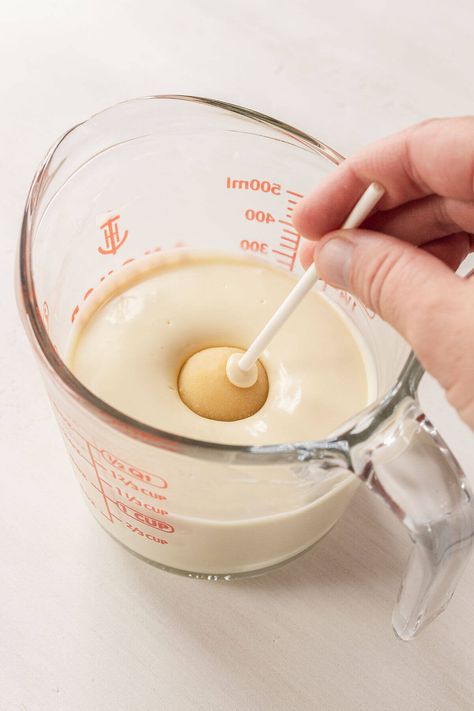 A vanilla cake pop being dunked into a glass of melted white chocolate. How To Melt White Chocolate For Dipping, How To Melt White Chocolate, Cake Pop Coating Recipe, Neutral Cake Pops, Vanilla Cake Pop, Vanilla Cake Pop Recipe, Cake Pop Icing, White Chocolate Cake Pops, Homemade Cake Pops