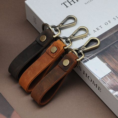 "Customized Leather Keychain for Him | Personalized Keychain Ring | Handmade Key Tag | Leather Key Holder | Coordinate Keychain | Keyfob Gift ⚠️REMINDER for PERSONALIZATION⚠️ If you do not specify a Design (Font or Logo) and Location for the personalization, your text will be engraved with Times New Roman BOLD (Like P-7 in the Design Image) vertically on the product (As shown in the Personalization Locations image). 🔑 Secure your keys with this elegantly made keychains. Handcrafted from high quality crazy horse leather, these key holders boast a strong structure with metal button joint. Featuring a sturdy metal key ring, this keychain comes with a strong metal clasp to attach the key fob to your bag, or belt. ⚖️Dimensions⚖️ 5x0.75 inches (12.7 × 1.9 cm) dimensions. ⚡How to Place a Persona Key Holder Leather Handmade, Keychain Leather Handmade, Keychains For Boyfriend, Leather Key Ring, Leather Key Chain, Leather Keychains, Leather Keychain Ideas, Scrap Leather Projects, Key Ring