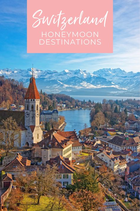 Aerial view of the medieval Switzerland city of Thun on a lake with snow-capped mountains in the background. A pink text box at the top reads, "Switzerland Honeymoon Destinations" Honeymoon Destinations Switzerland, Switzerland Honeymoon Winter, Switzerland Honeymoon Romantic, Honeymoon In Switzerland, Scandinavian Honeymoon, Honeymoon Switzerland, Fire Gazing, Swiss Honeymoon, Mountain Honeymoon