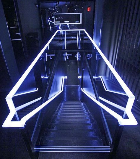 So here we have a futuristic looking escalator. It has the neon lights and the glass, although the actual stair pieces look older because they're a bit dirty and have a rough texture.: Club Lighting, Nightclub Design, Lounge Bar, Stair Lighting, Futuristic Interior, Exhibition Stand Design, Design Stand, Interior Stairs, Gym Design