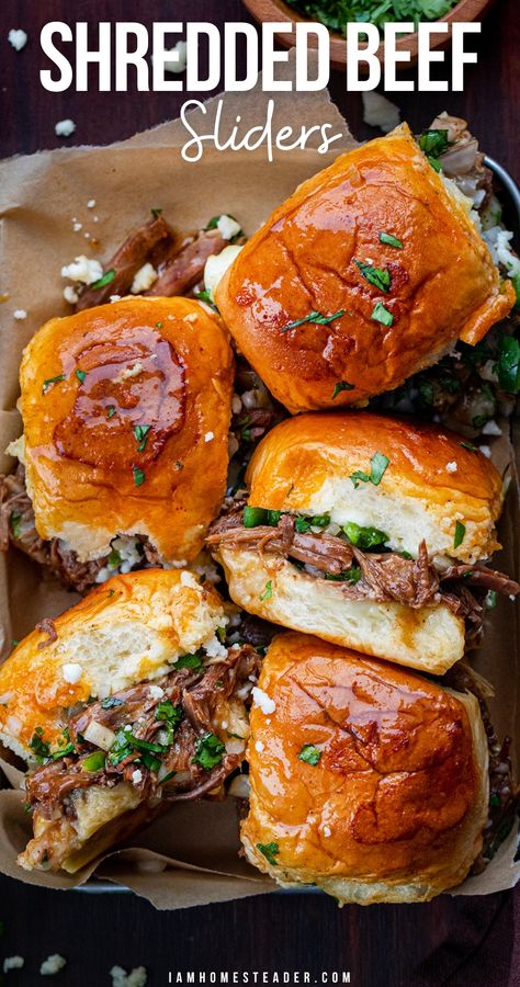 Sliders in a parchment lined tray, some turned on their side. Flank Steak Shredded Beef, Roasted Beef Sandwich Recipes, Bbq Shredded Beef Sandwiches, Crockpot Shredded Meat Recipes, Crowd Meals Dinners, Shredded Beef Baked Potato, Beef Brunch Ideas, Crockpot Beef Sliders Recipes, Crockpot Beef Sliders