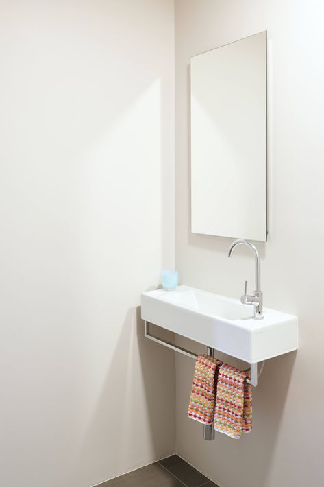 Suburban-Staid No More: A Stylish New California-French Look for a Bay Area House Wall Mounted Sink Powder Room, Sink With Towel Bar, Tiny Bathroom Sink, Wide Oak Flooring, Tiny Powder Room, Powder Room Sink, Midcentury House, Black Floor Tiles, Folding Glass Doors