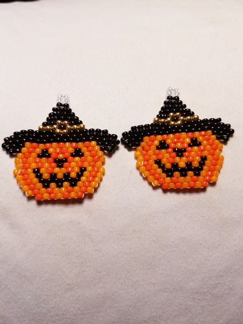 Pretty pumpkin earrings with a witchy hat. Great for Halloween parties. Made with glass beads and Wildfire beading thread. They are an inch and a quarter long and an inch and a half at the widest. Beaded Pumpkin Earrings, Halloween Beaded Earrings, Beaded Pumpkin, Thanksgiving Earrings, Pretty Pumpkins, Pumpkin Bead, Halloween Beads, Beading Thread, Beaded Earrings Diy