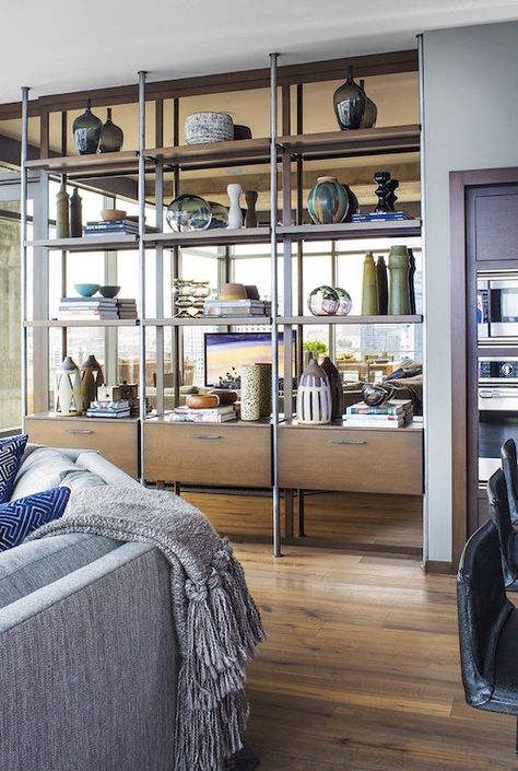 My favorite way to add storage is to do it as inconspicuously as possible,” says Jeff Andrews, who designed this shelving unit of oak and pewter-plated steel with a bronzed mirrored backing for a loft in downtown Los Angeles. The shelves feature ceramic pieces by Adam Silverman, Victoria Morris and Heather Levine.  Photo by Grey Crawford Jeff Andrews Design, Open Bookshelves, Wall Mirror With Shelf, Townhouse Designs, Wall Bookshelves, Living Room Shelves, Room Shelves, Home Addition, Mirror With Shelf