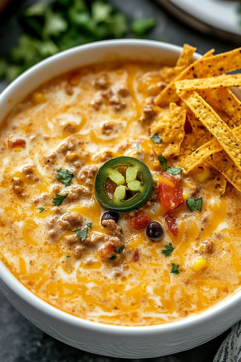 There's something undeniably comforting about a warm bowl of soup, especially when it’s loaded with all the bold, zesty flavors of your favorite Tex-Mex dish. That’s exactly what you get with this Slow Cooker Nacho Soup. It’s rich, cheesy, and packed with ingredients that will make your taste buds do a happy dance. Whether you're Nacho Soup Crockpot, Slow Cooker Cheesy Burger Flavored Soup, Crockpot Nacho Dip, Fiesta Nacho Cheese Soup Recipes, Crock Pot Mexican Recipes, Nacho Cheese Soup Recipe, Slow Cooker Nacho Soup, Nacho Cheese Soup, Nacho Soup