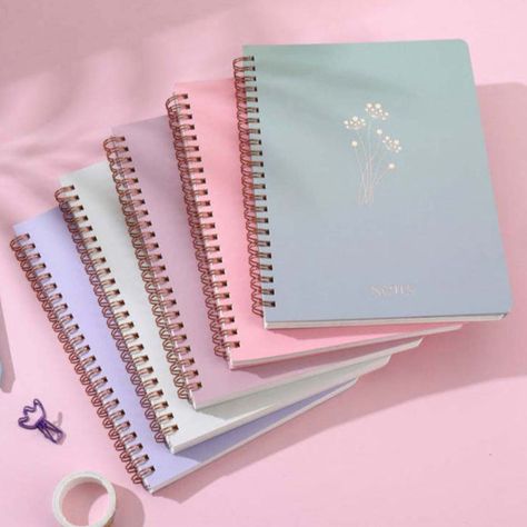 Add a touch of elegance to your writing with the Serenity Bloom Spiral Notebook! Featuring pastel-hued covers adorned with a delicate floral design and shimmering gold foil, this notebook is both stylish and practical. The double-coil ring binding and pre-cut lined pages make tearing out notes neat and hassle-free. Ideal for journaling, morning pages, classes, or work, it even includes a handy pocket for storing your essentials. Number of pages: 160 Size: 21 cm x 16.5 cm Aesthetic Note Book, Aesthetic Note, Notebooks For School, Binder Paper, Back To School Stuff, Coil Ring, Morning Pages, Kawaii Pens, Cute Journals