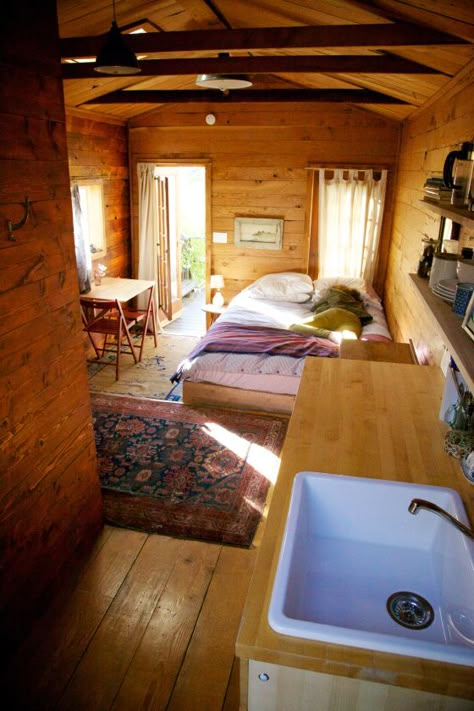 Tiny Cabin Living Room, Simple Cabin Interior, Tiny Cabin Living, Green Glass Door, Airbnb Cottage, Airbnb Cabin, One Room Cabin, Room Oasis, Cozy Cabin In The Woods