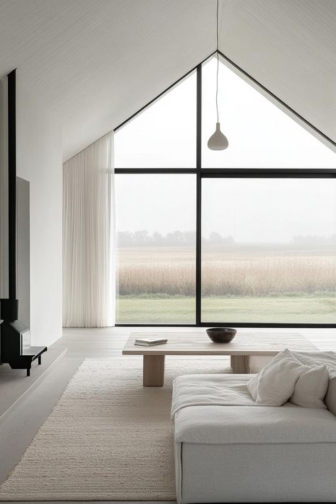 Modern farmhouse minimalist Scandinavian interior with large windoes overlooking poppy fields. Get inspired by all of these modern farmhouses that blend rustic charm with sleek, contemporary design for a cozy yet sophisticated home. Modern Farm Fireplace Ideas, Modern House Scandinavian, Minimalist Architecture Interior, Modern Farm Houses, Minimalist House Design Interior, Contemporary Farmhouse Interior, Scandinavian Modern Interior, Minimalist Scandinavian Interior, Modern Minimalist House Design