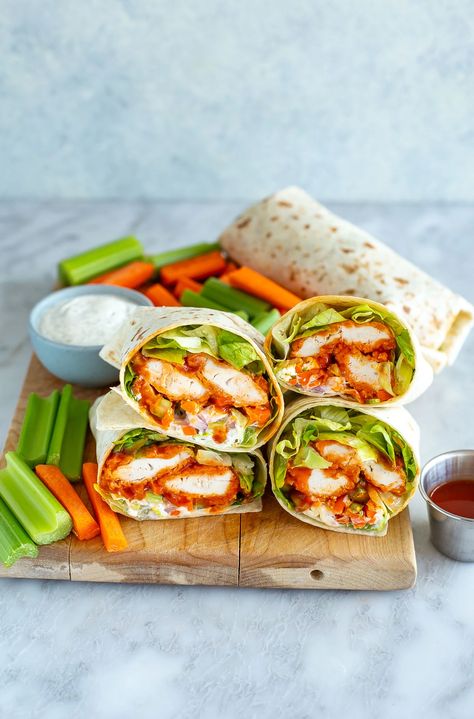 The BEST Crunchy Buffalo Chicken Wraps - The Girl on Bloor Buffalo Wrap, Wraps Chicken, Buffalo Chicken Wrap, Buffalo Chicken Tenders, Buffalo Chicken Wraps, Baked Chicken Tenders, Dehydrated Onions, Crispy Baked Chicken, Chicken Wrap