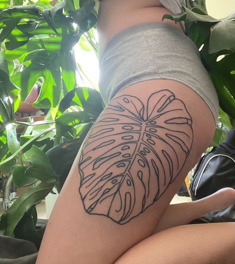 A monstera leaf thigh tattoo done in simple linework Linework Plant Tattoo, Monstera Leaf Tattoos, Monstera Tattoo Thigh, Monstera Plant Tattoo Design, Monstera Leg Tattoo, Plant Tattoo Thigh, Plant Inspired Tattoos, Prayer Plant Tattoo, Plant Hip Tattoo