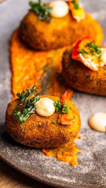 Dennis Prescott on Instagram: "Holiday Appetizer Deliciousness = Lobster Croquettes With Romesco & Garlicky Mayo. Shareable Bite-Sized New Brunswick Flavoured Goodness. Full Recipe Below! Lobster Croquettes 2 cups mashed potatoes 1/2 cup finely chopped lobster meat, plus more to serve 1 tablespoon minced chives 1 tablespoon minced tarragon Zest of 1 lemon, grated on a microplane 1/4 cup crumbled goat cheese 2 cups flour, divided 3 eggs, whisked 2 cups seasoned breadcrumbs Neutral oil, for frying Sea salt Minced chives, parsley, and lemon wedges Romesco 1 large roasted bell pepper from a jar 2 garlic cloves, roughly chopped ½ cup slivered almonds, toasted ¼ cup tomato puree 2 tablespoons chopped flat-leaf parsley 2 tablespoons sherry vinegar 1 teaspoon smoked paprika ½ c Lobster Croquette, Dennis Prescott, Crumbled Goat Cheese, Tomato Puree, Lobster Meat, Holiday Appetizer, Sherry Vinegar, 3 Eggs, Holiday Appetizers