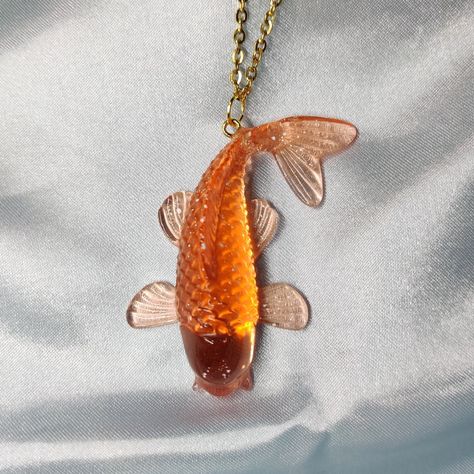 A cute translucent koi fish, with occasional white specks. The metal is plated stainless steel for a hypoallergenic option. Jewelry Care: Avoid sleeping, swimming, and submerging the pieces. Oils may wear on the resin finish. Use alcohol wipes only on metal portion for cleaning. Weirdcore Necklace, Koi Fish Jewelry, Squid Jewelry, Weird Accessories, Lobster Jewelry, Cool Accessories, Weird Jewelry, Alcohol Wipes, Fish Jewelry