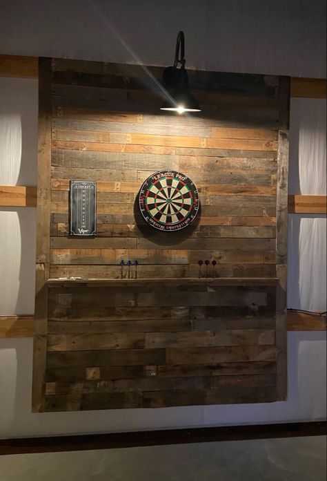 Dartboard wall made from weathered pallet wood. Dartboard Wall Ideas, Basement Dart Board Ideas, Dart Board Lighting Ideas, Dart Board Wood Wall, Dart Board Wall Diy, Garage Pallet Wall, Basement Dart Board Wall, Pallet Dart Board Wall, Dartboard Wall