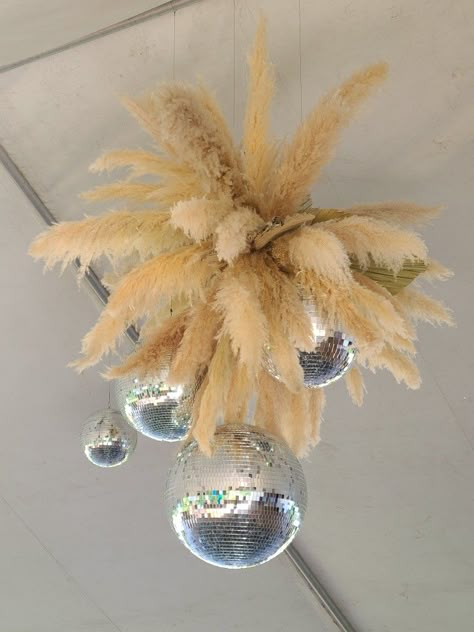 Pampas grass and disco balls combined to make the perfect centerpiece in this tent top for the boho glam wedding. Pampas Grass Disco Ball, Pampas And Disco Ball Wedding, Rustic Glam Decor Wedding, Pampas Disco Ball, Boho Disco Party, Rustic Glam Decor, Country Prom, Boho Glam Wedding, Glam Chandelier