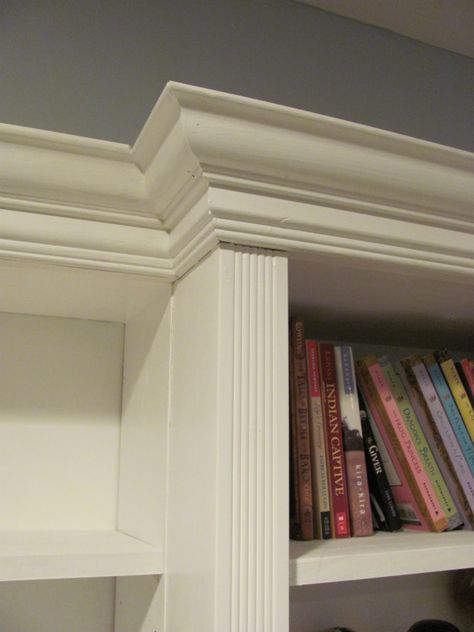 We found some lovely, wide crown moulding and some fluted trim at Habitat REstore (if you have a Habitat for Humanity REstore near you, you ought to check it out!  The prices are amazing!)  Since this was going to be a long wall of shelves, we divided it up into thirds and bumped out the center section to add visual interest. Bookshelf Molding, Bookshelf Furniture, Moulding Ideas, Molding Detail, Classic Bookshelves, Entertainment Rooms, Molding Ideas, Wood Library, Rumpus Room